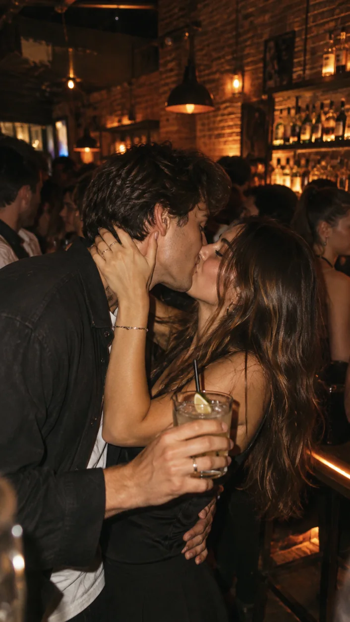 A couple kissing in a warm crowded bar in Rimini